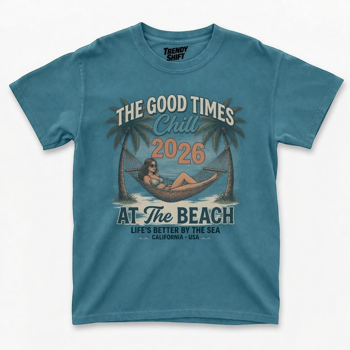 TrendyShift.Com blue graphic t-shirt featuring a retro beach hammock scene with palm trees and summer text.