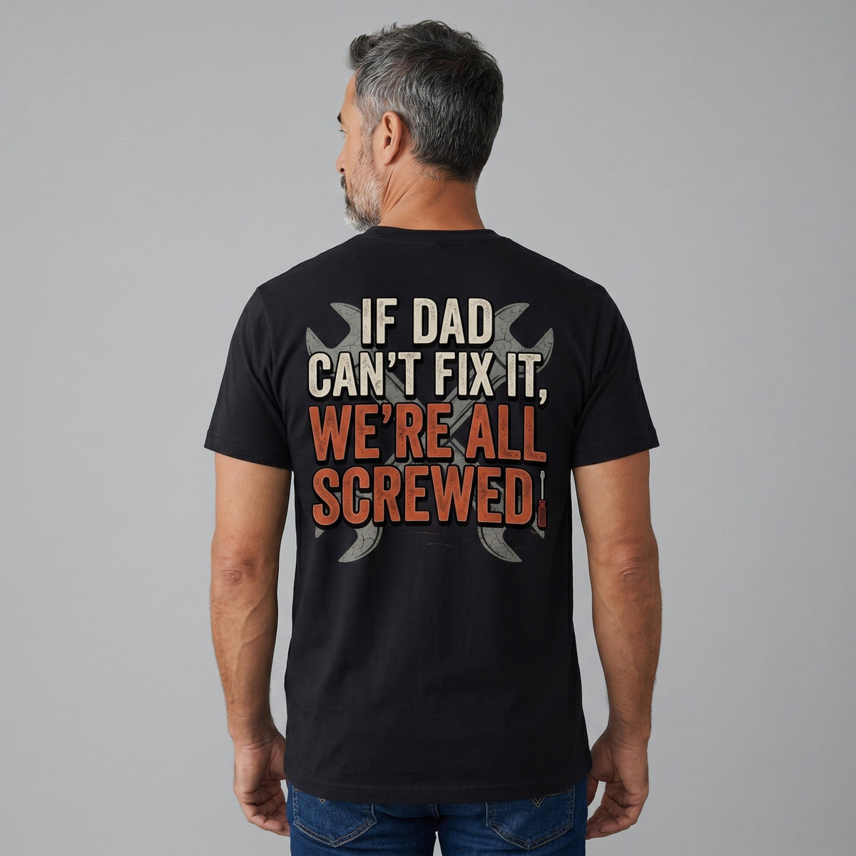 TrendyShift.Com black unisex crew neck t-shirt with Dad's Repair Shop graphic on back worn by a man from behind