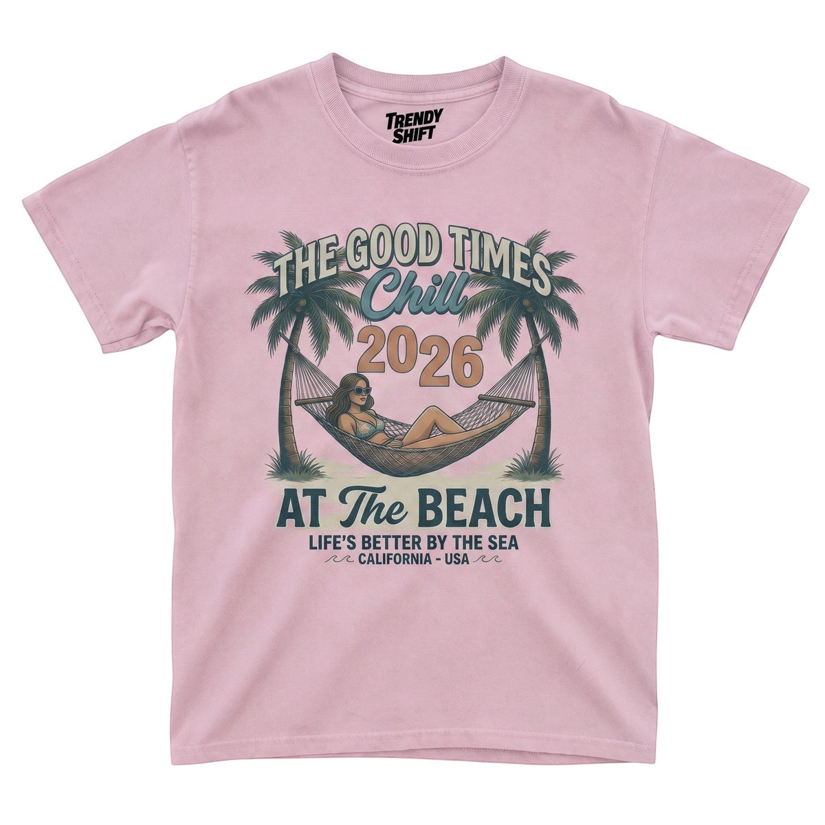 TrendyShift.Com light pink graphic t-shirt featuring a retro beach hammock scene with palm trees and summer text.