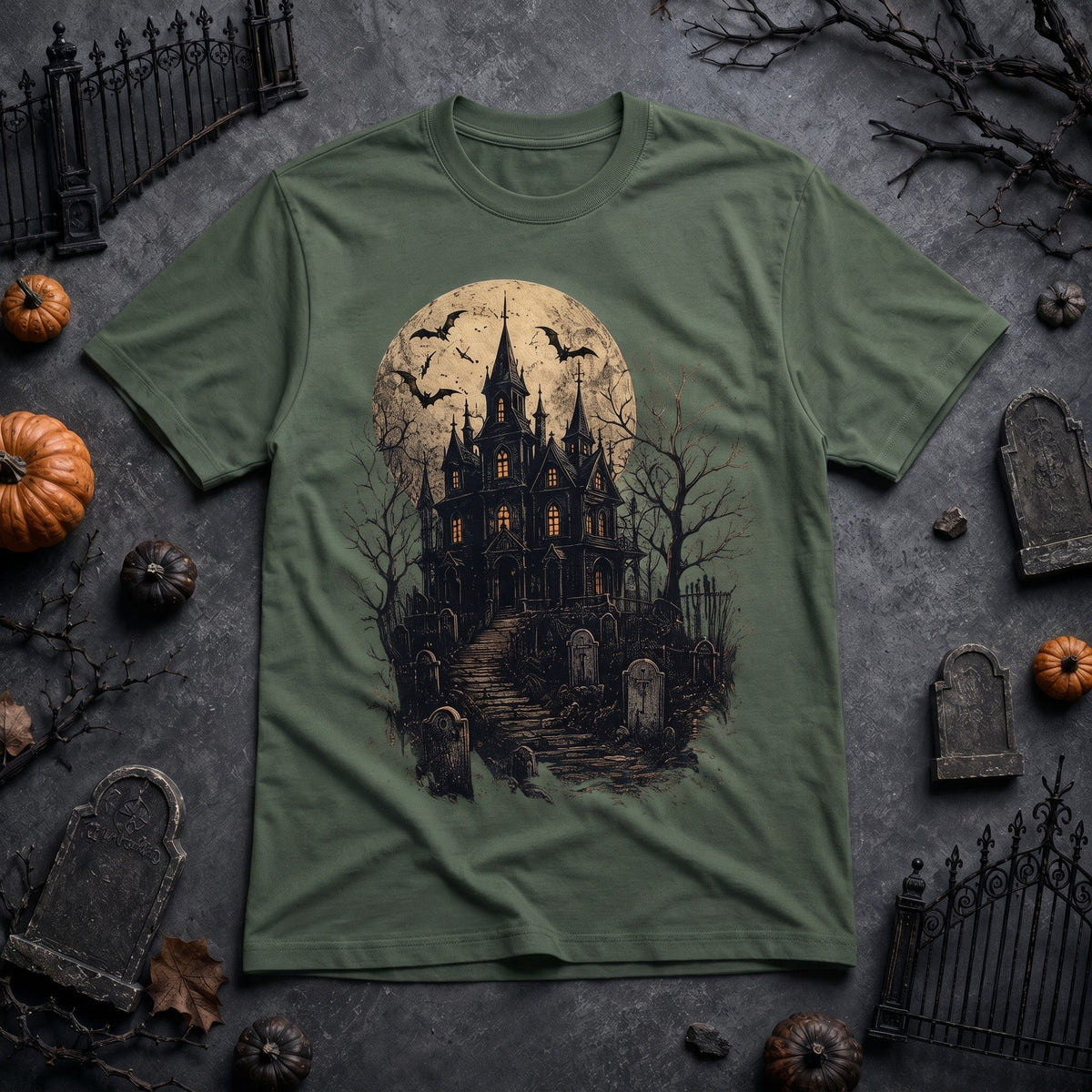 WearTheJoke.com olive green crew neck t-shirt featuring a spooky haunted house, graveyard, and full moon graphic.
